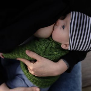 Breastfeeding baby in green